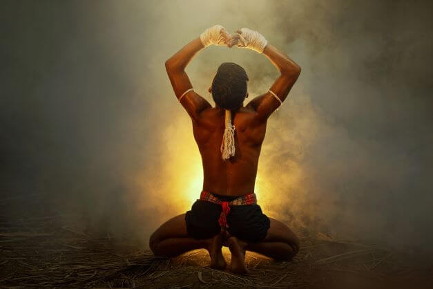 What Is Muay Thai? The Art of Eight Limbs Explained 1 Muay Thai boxer on his knees