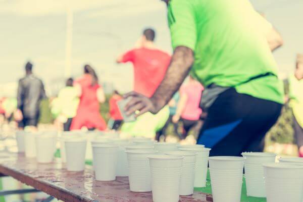 How To Break The 45 Minute Mark For A 10K Run 2 A runner taking on fluids during a race