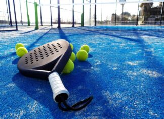 Padel Explained: How to Play, Score and Understand the Rules Padel racket and several balls resting on a blue outdoor padel court