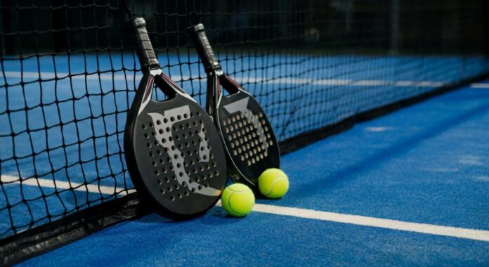 two padel bat and balls on a padel court