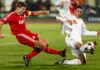 Steven Gerrard shooting for Liverpool as a Debrecen defender attempts to block
